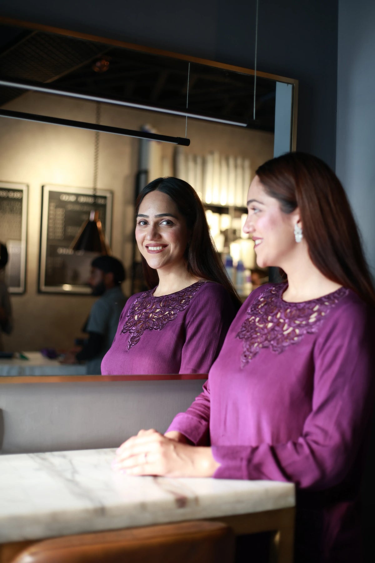 Woman wearing lavender purple kurti with embroidered neckline, mirror reflection shot
