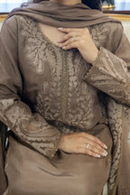 Close-up of grey kurta with intricate embroidered neckline and sleeves, matching dupatta draped over shoulder